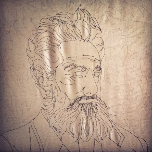 Acanthus leaves drawn onto the background of the finished sewn portrait.